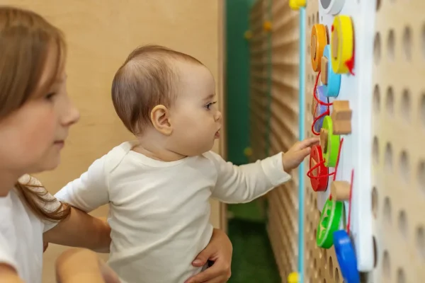 toddler-learning-with-interactive-wall-toy-and-tea-2026-03-27-00-48-46-utc